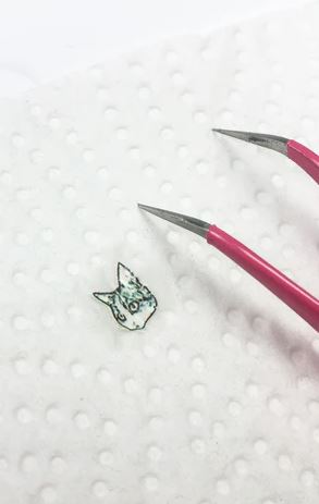 cutting out the waterslide nail decal